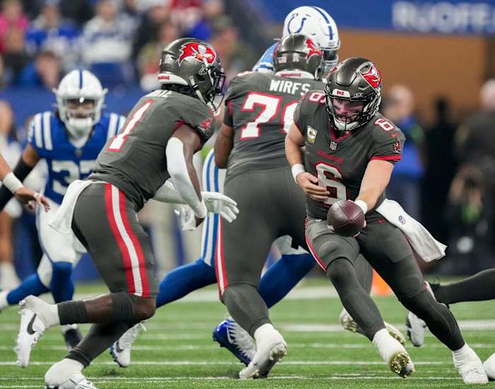 Tampa Bay Buccaneers quarterback Baker Mayfield (6) looks to hand the ball to Tampa Bay Buccaneers running back Rachaad White (1) on Sunday, Nov. 26, 2023, during a game against the Indianapolis Colts at Lucas Oil Stadium in Indianapolis.